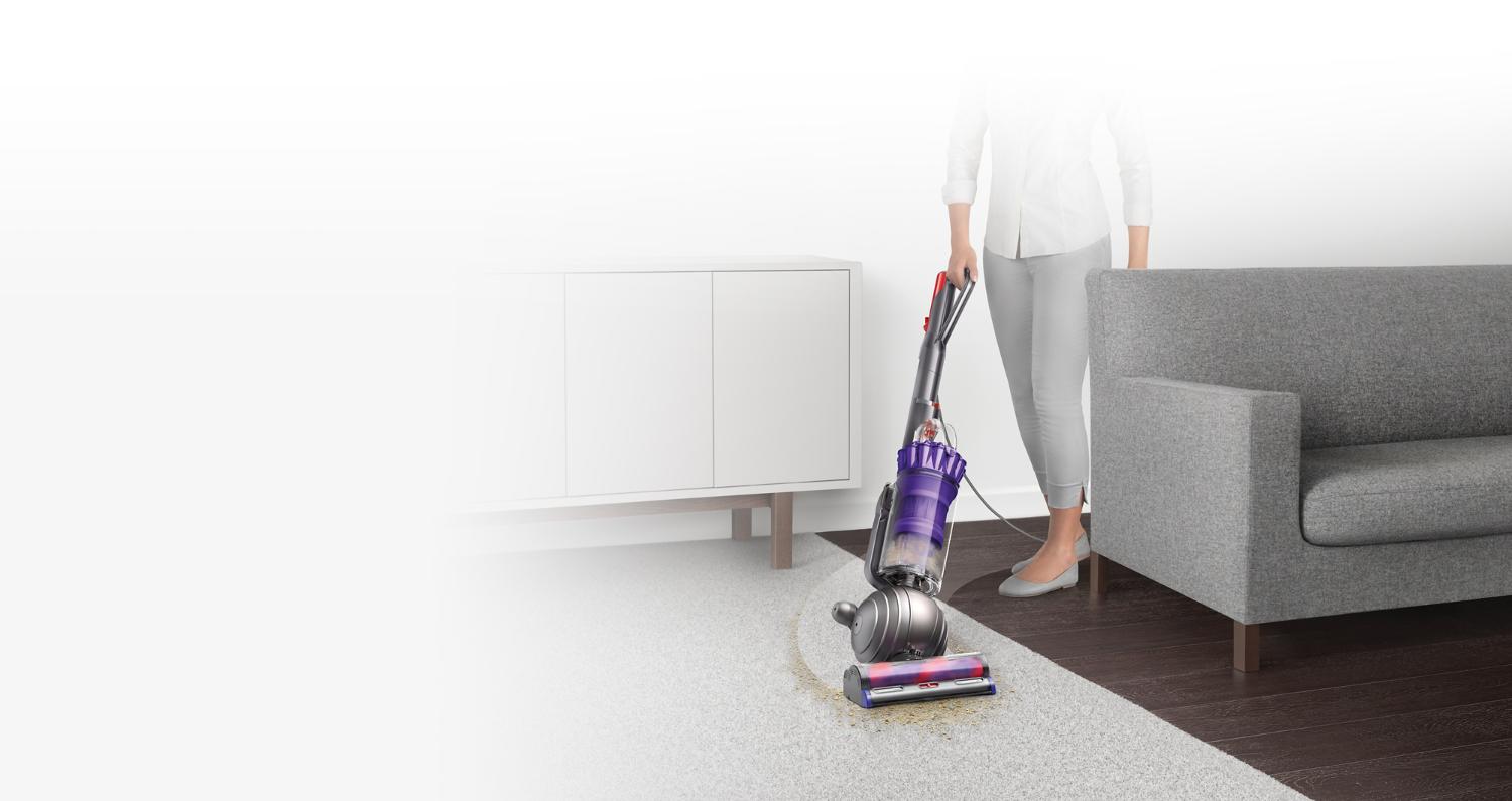 Dyson Light Ball Animal upright vacuum being used on carpet